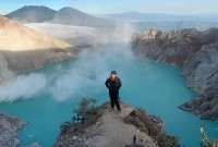 Traveler overlooking Ijen Crater lake
