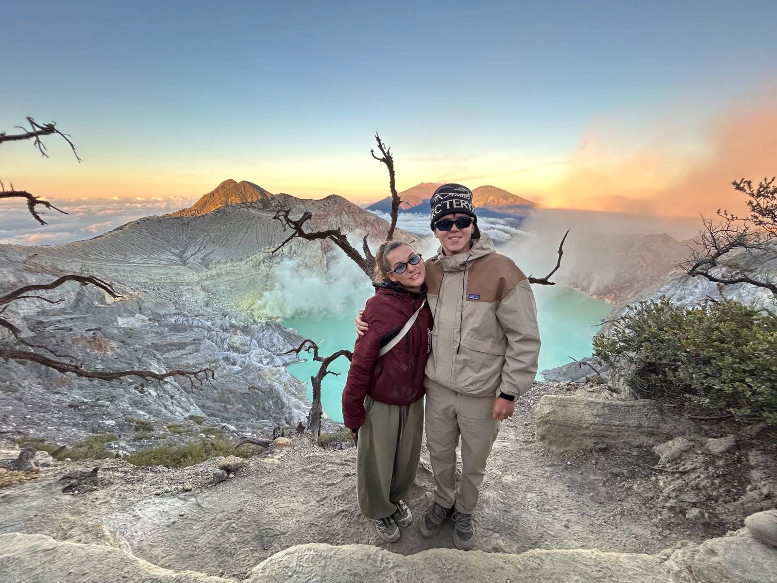 Travellers overlooking the clear turquoise Ijen Crater