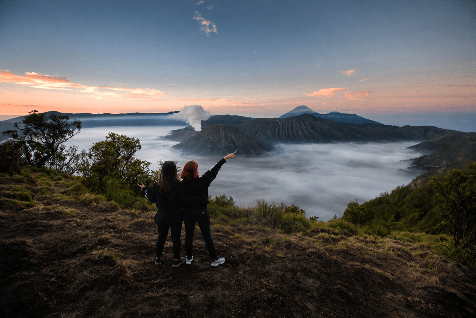 Travellers watching sunrise at Mount Bromo